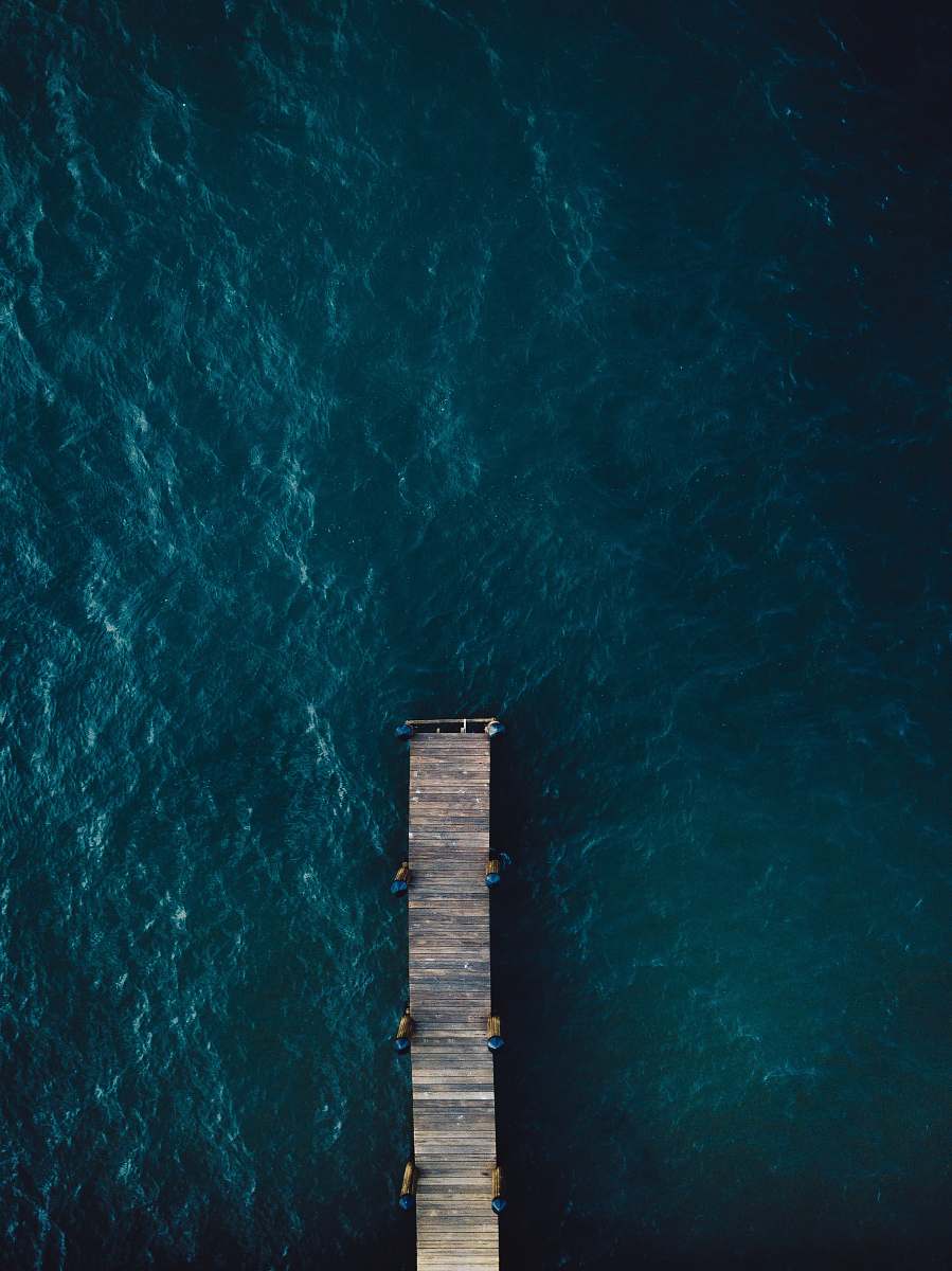 grey brown wooden bridge on body of water marco island